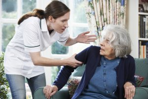 Photo of a Care Worker Mistreating Senior Woman At Nursing Home